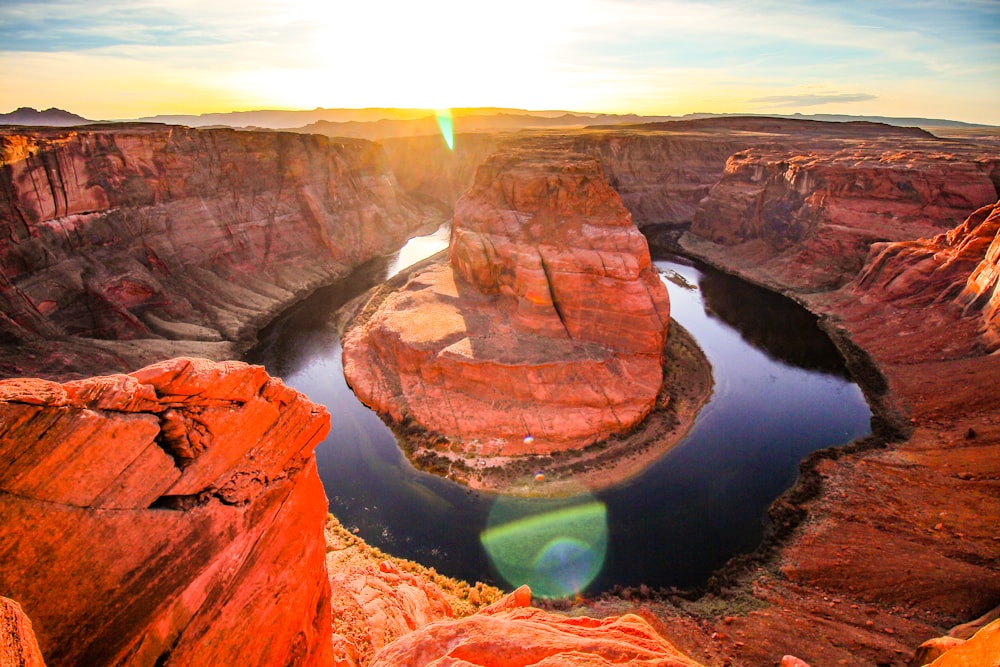 brown rock formation beside body of water during daytime