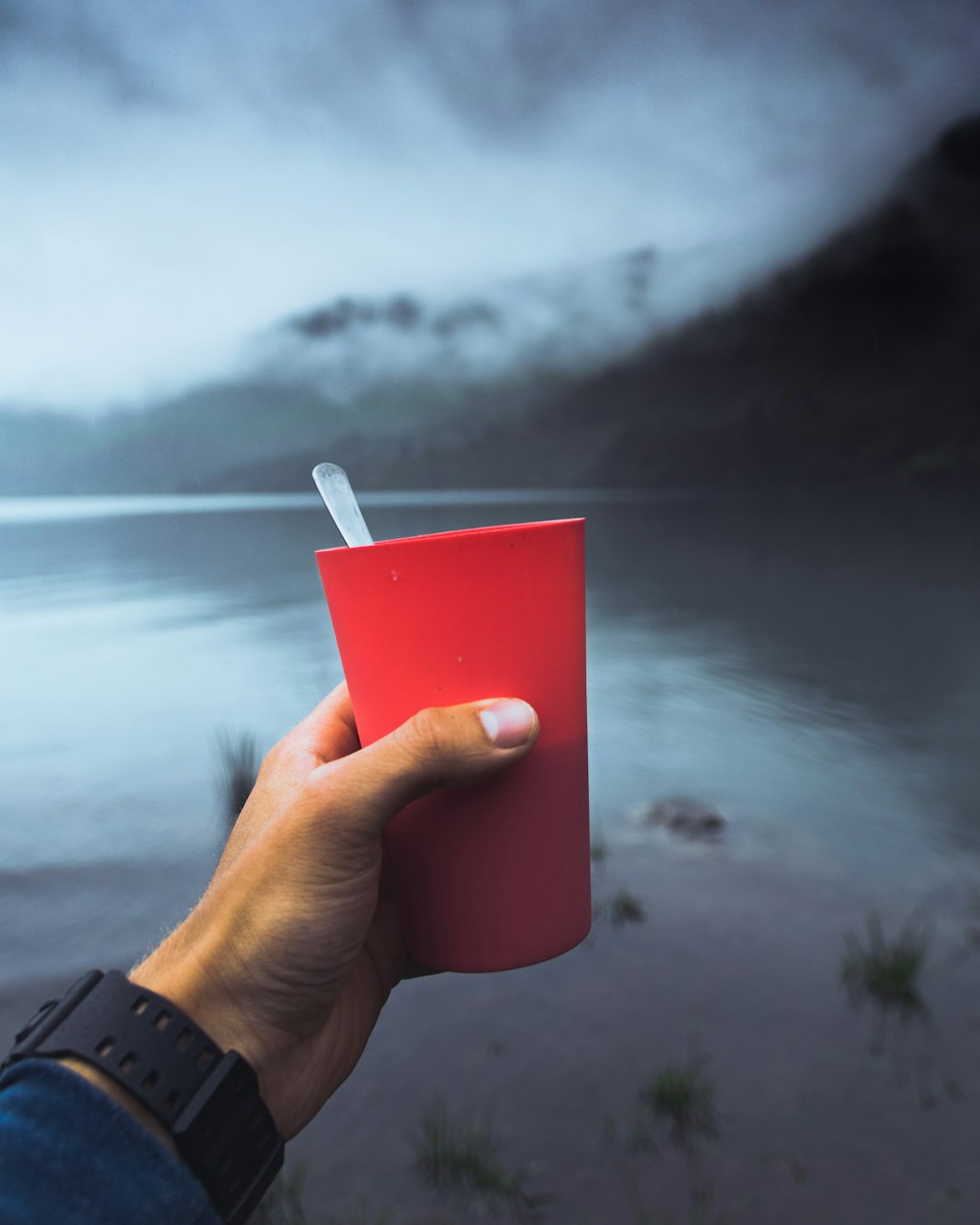 person holding red plastic cup