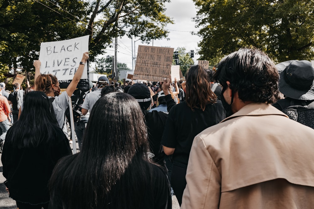 people gathering in front of brown building during daytime