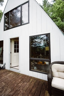 Family enjoying the porch of their new prefabricated home with wood accents and open space.