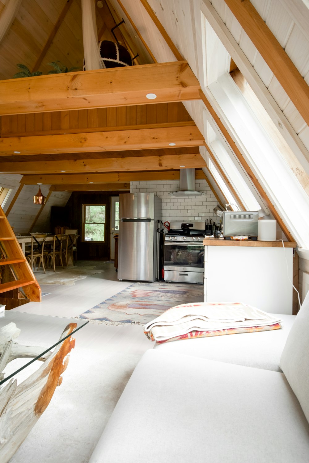 white top mount refrigerator beside brown wooden dining table