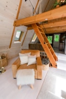 brown wooden staircase near white sofa