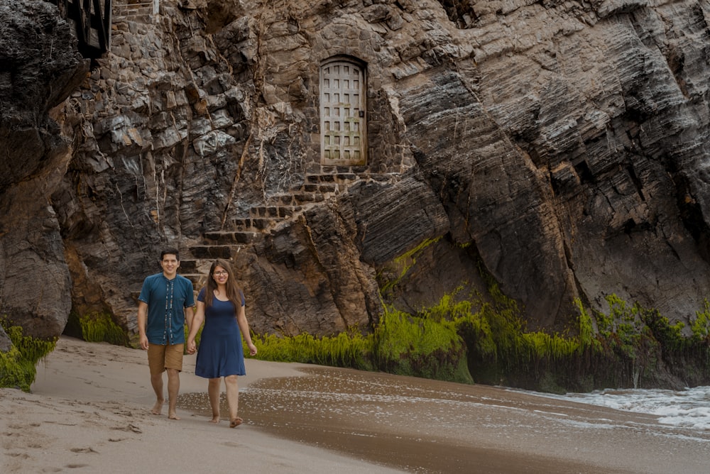 a man and a woman walking on a beach