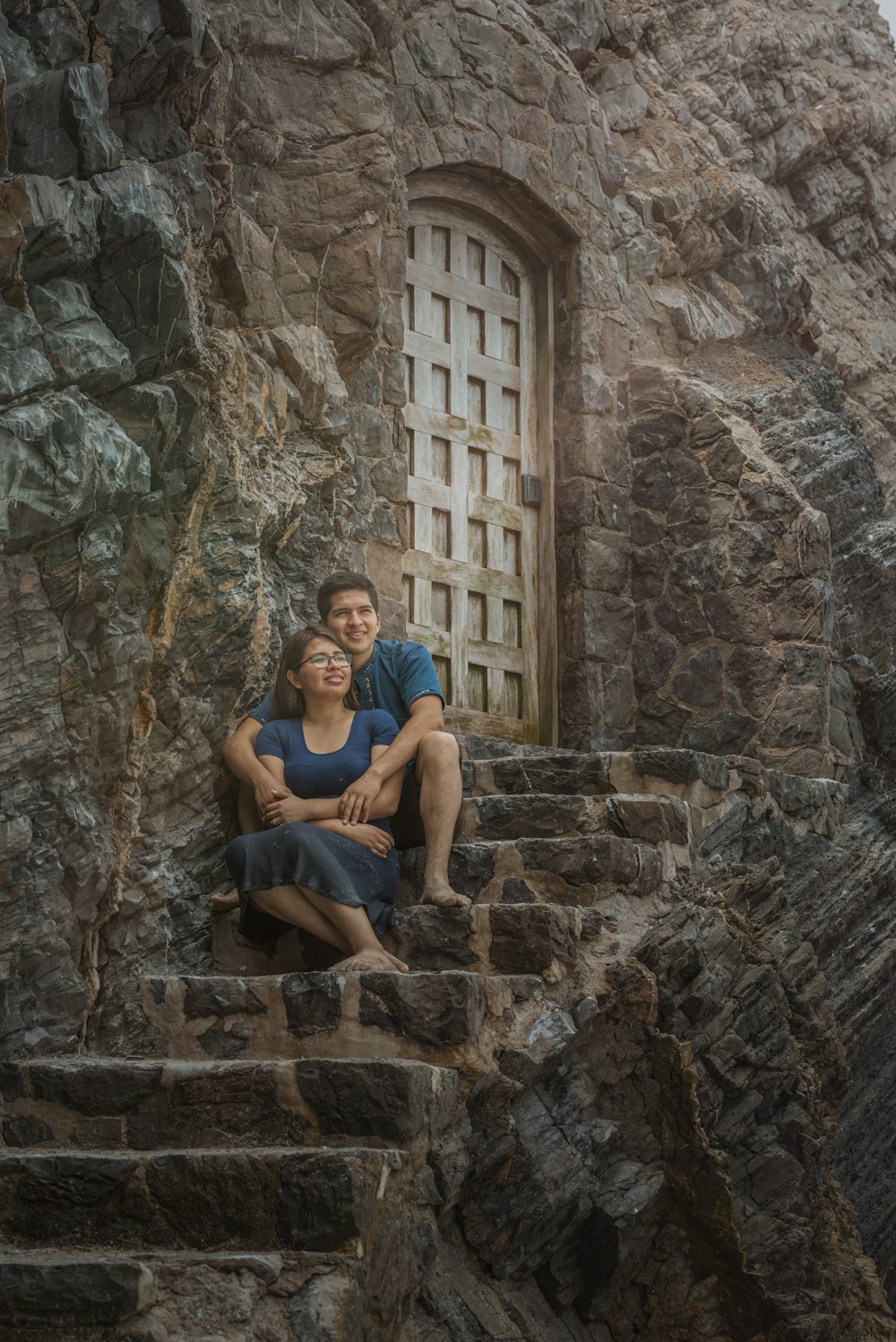 a man and a woman sitting on some stairs