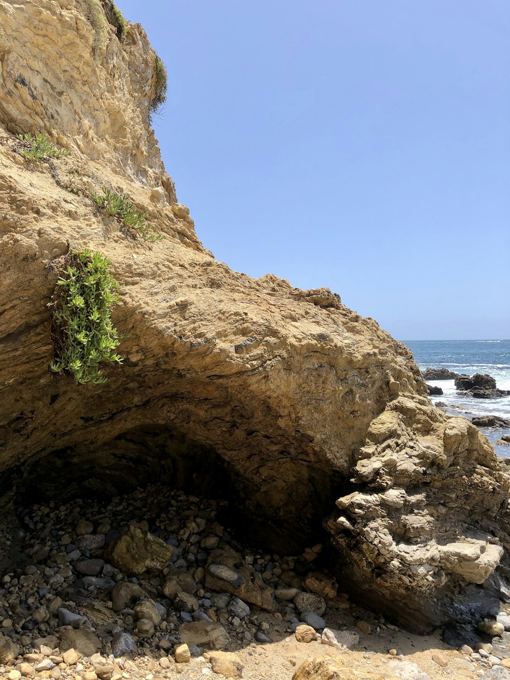 Formazione rocciosa marrone vicino allo specchio d'acqua durante il giorno