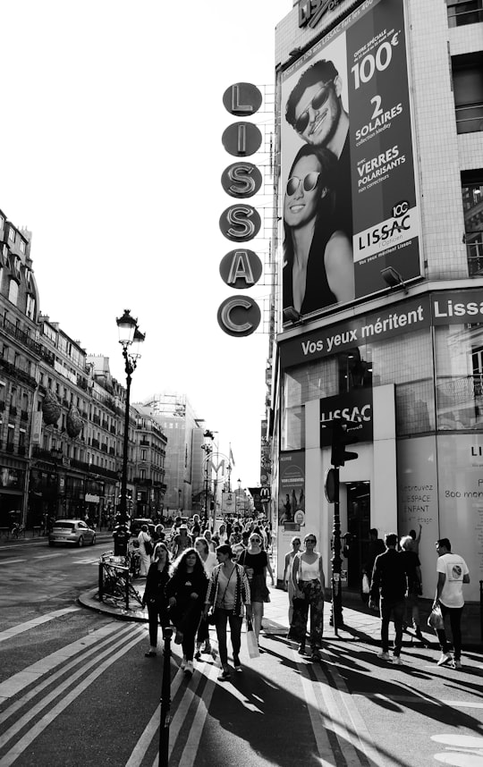grayscale photo of people walking on street in Rue de Rivoli France