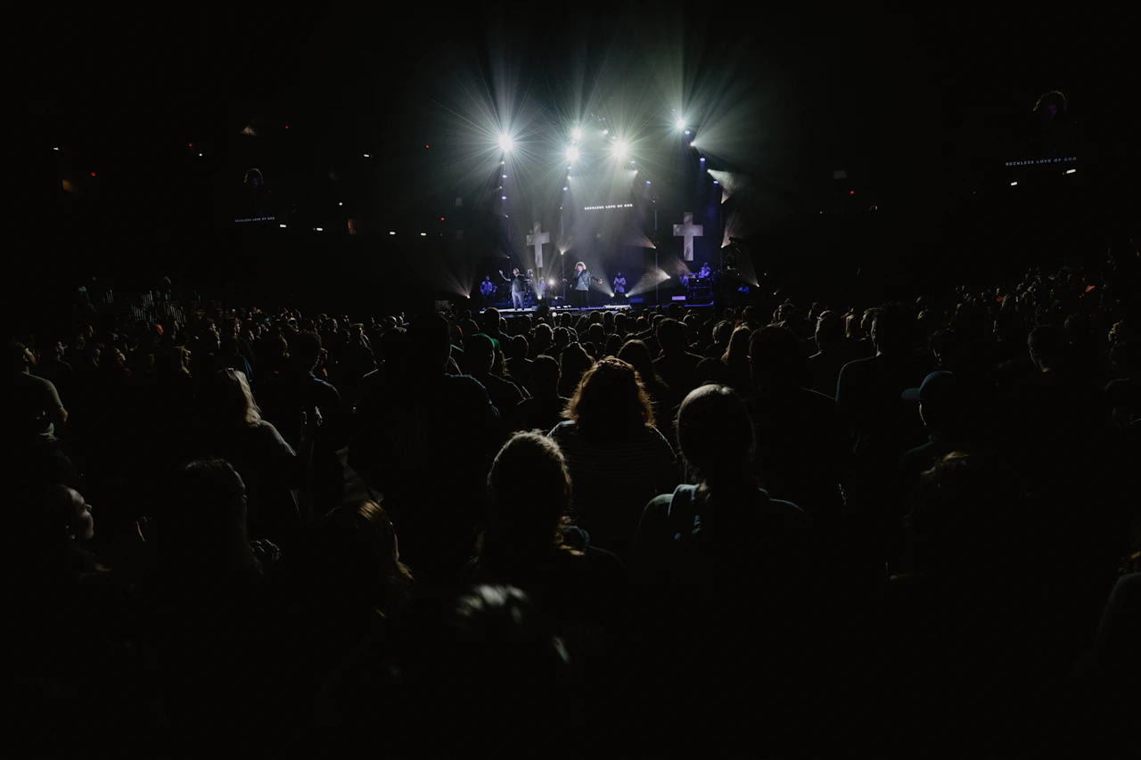 Concert audience at night — your website turns first-time visitors into long-term fans that your EPK alone never could