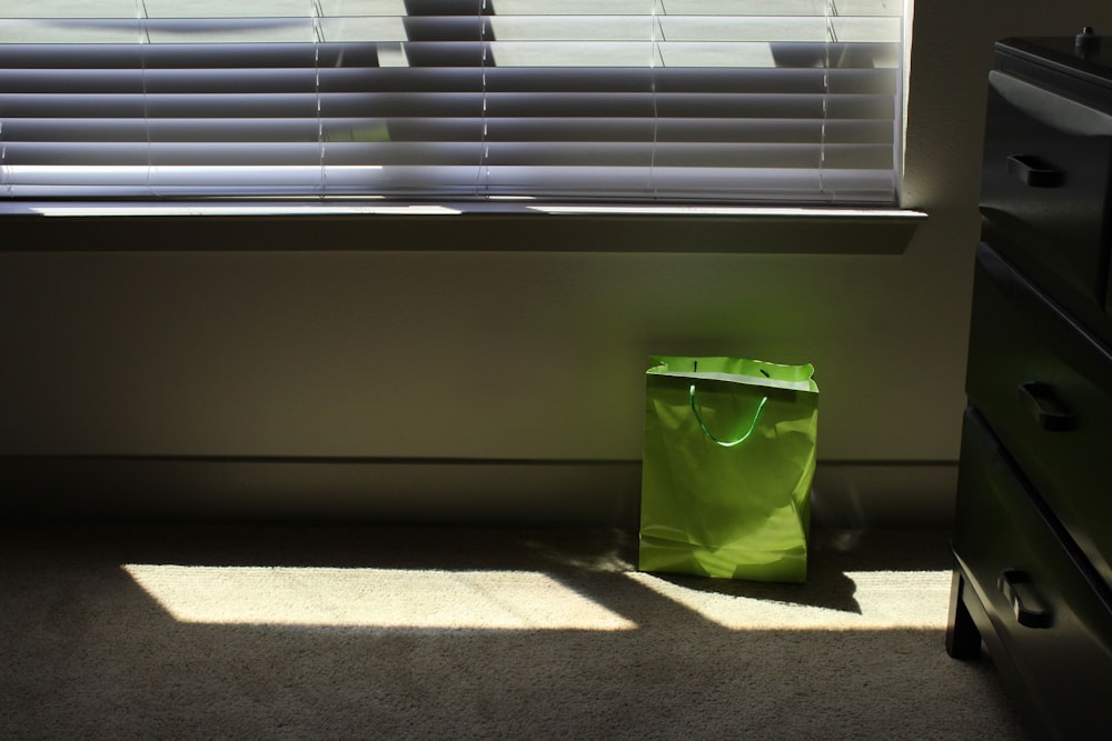 green tote bag on floor