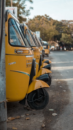 A fleet of well-maintained tempos lined up at the raju tempo transport services stand, ready for dispatch.