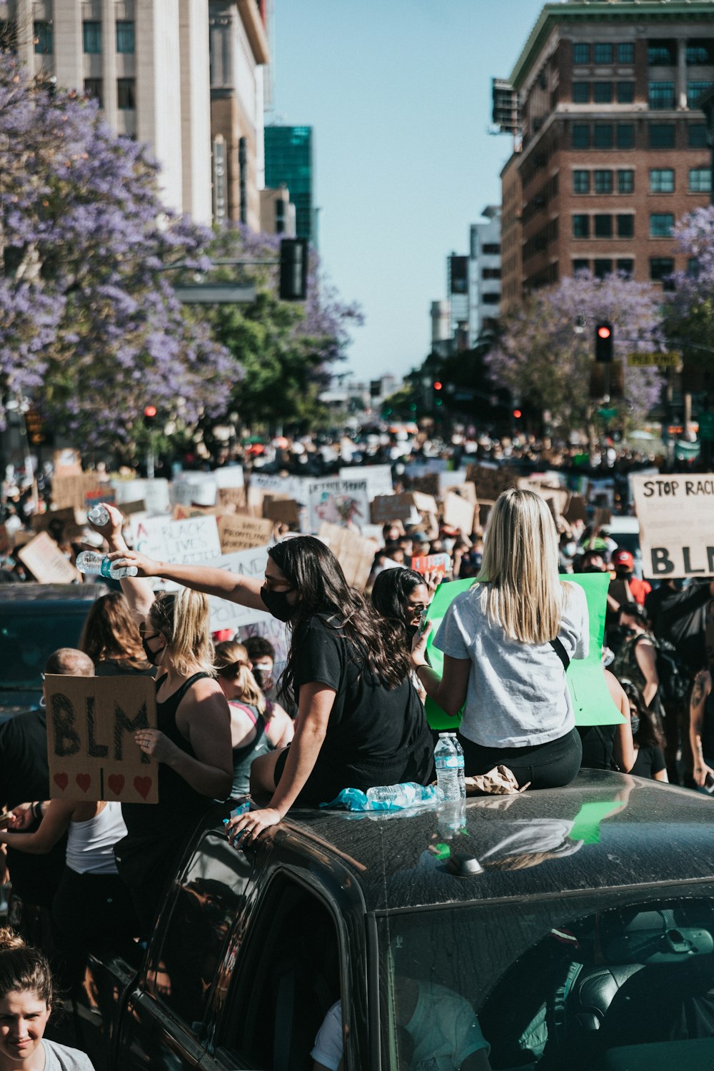 people sitting on gray concrete bench during daytime