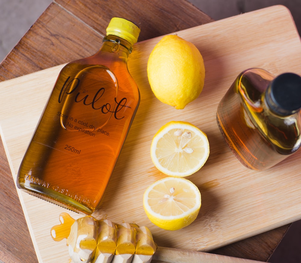 lemon and brown glass bottle on brown wooden table