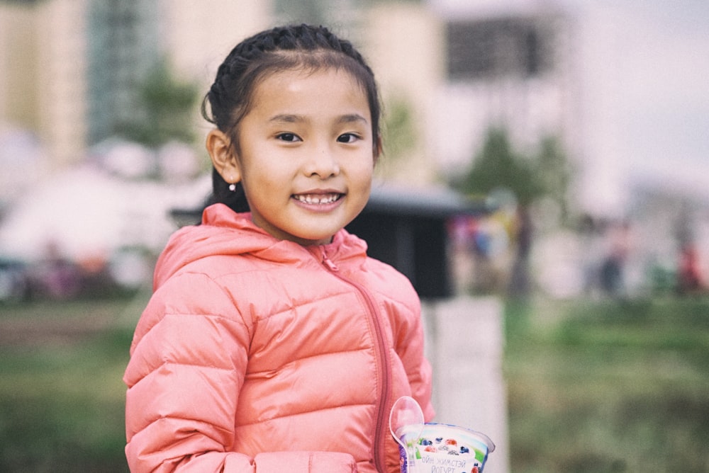 girl in orange jacket smiling