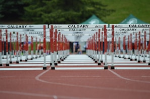 red and white metal fence on brown concrete road