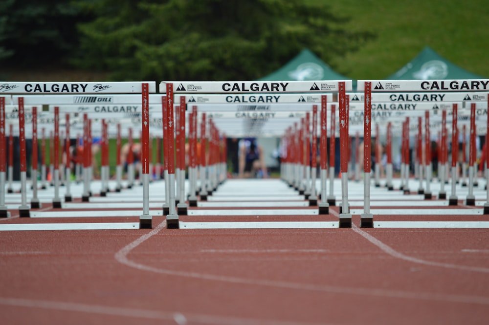 red and white metal fence on brown concrete road