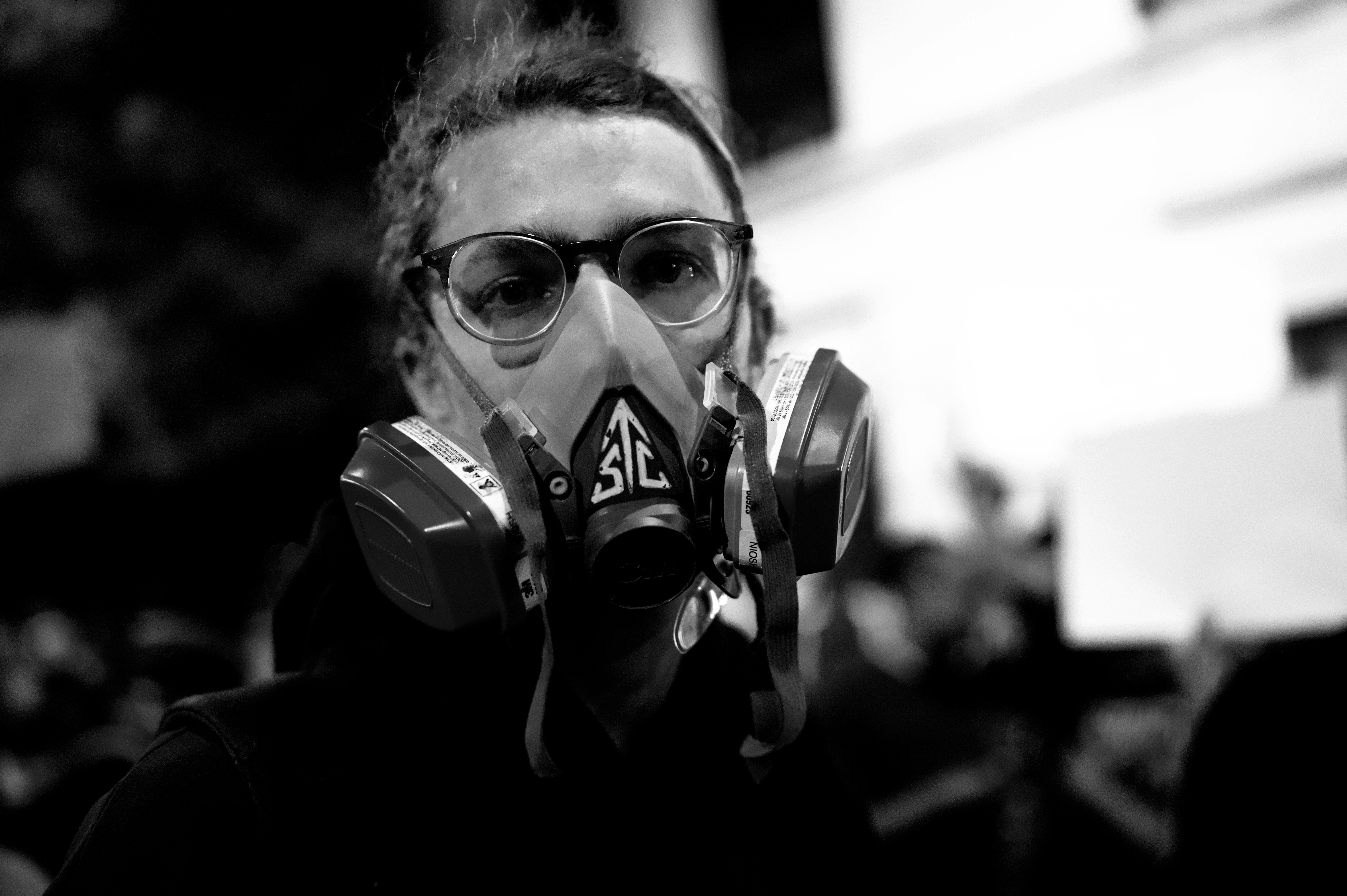 grayscale photo of person wearing gas mask