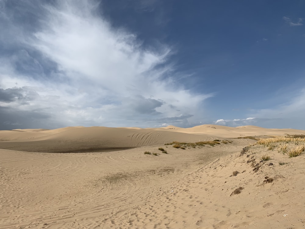 brown sand under blue sky during daytime