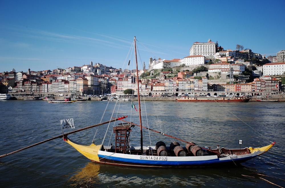 man in blue and white boat on water during daytime