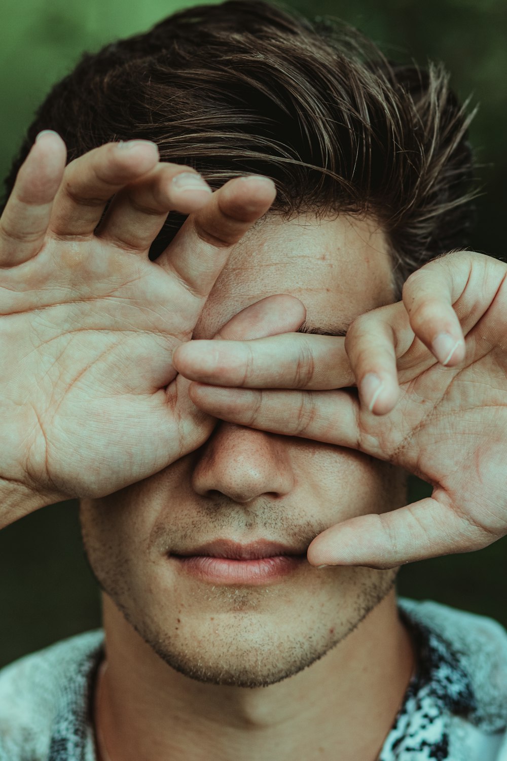 man holding his face during daytime