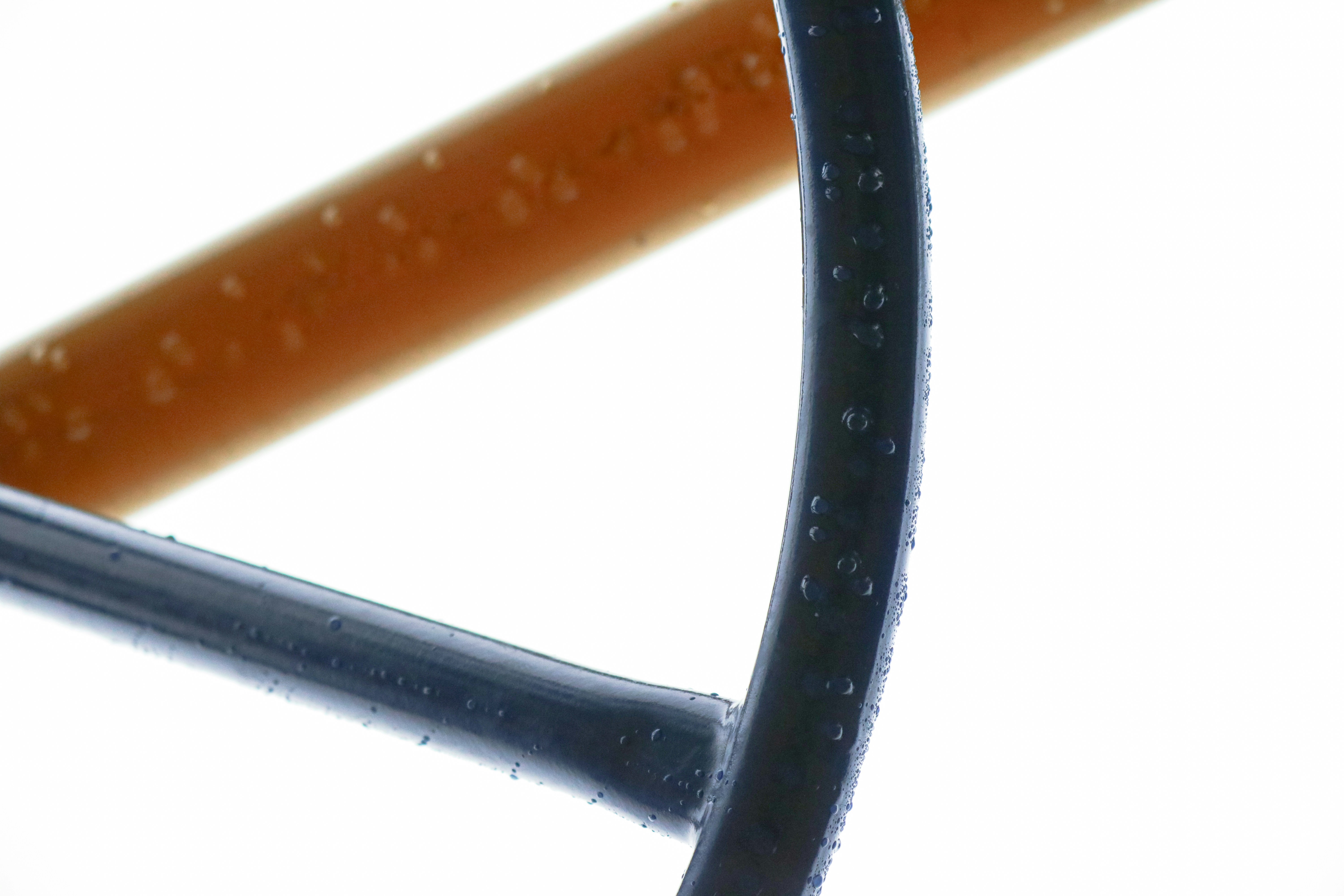 Close-up of drip irrigation tubing coiled on clean white background, bright product photography