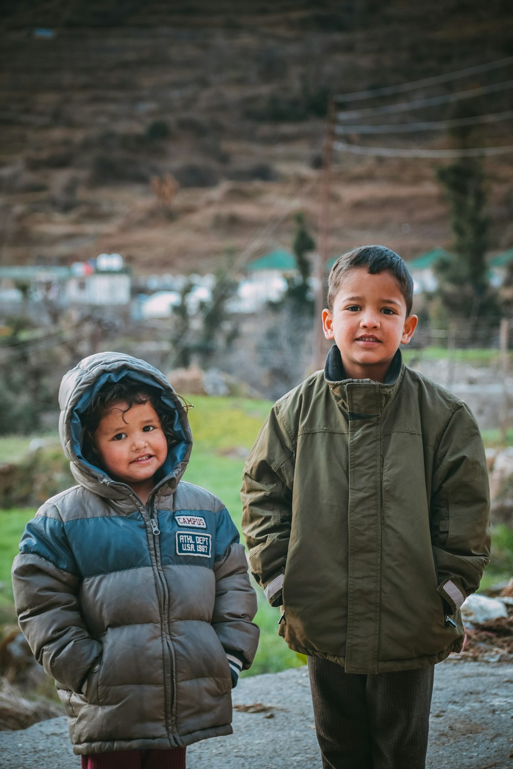 man in gray jacket beside boy in gray jacket