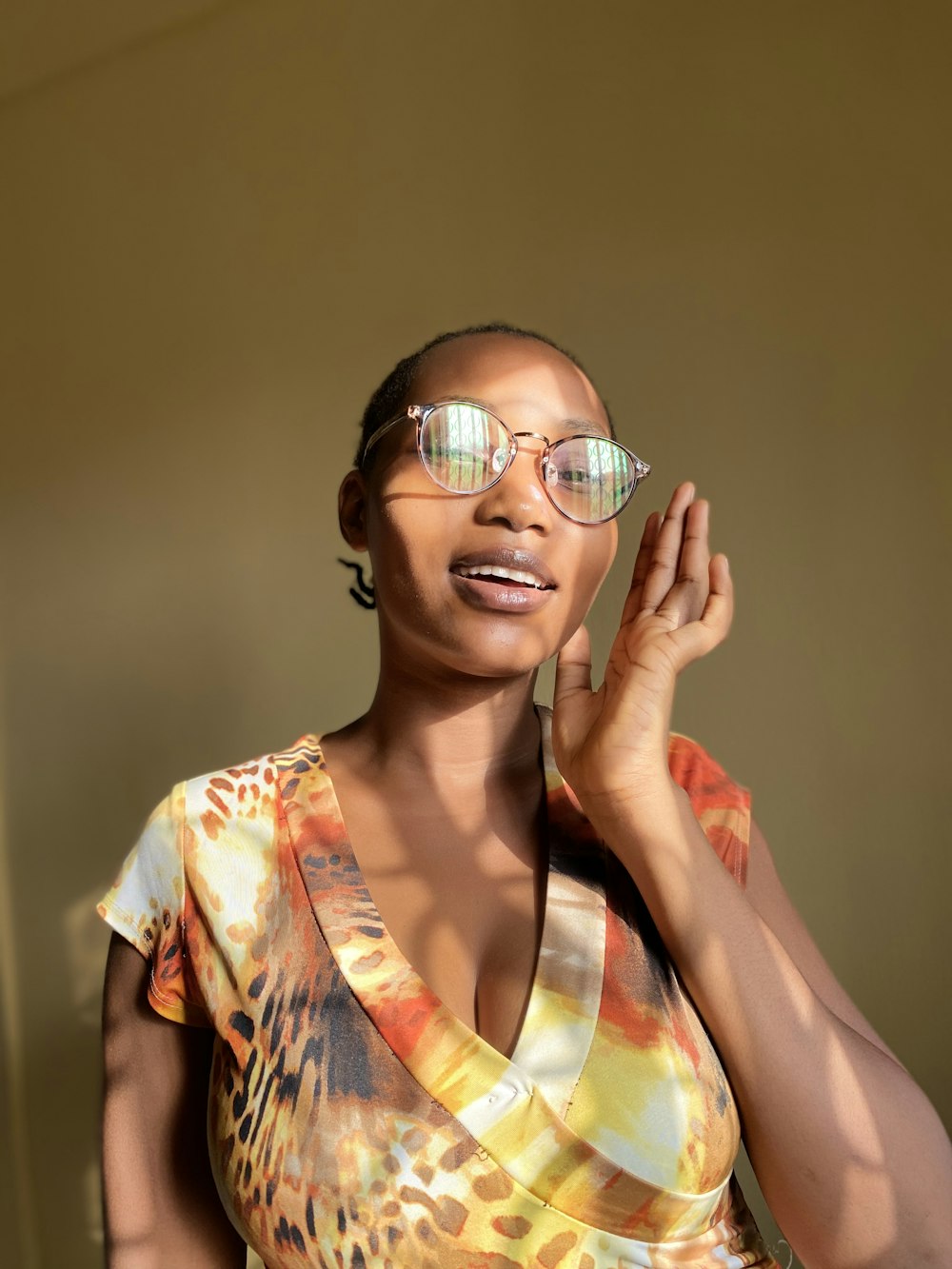 girl in yellow and red floral dress wearing eyeglasses