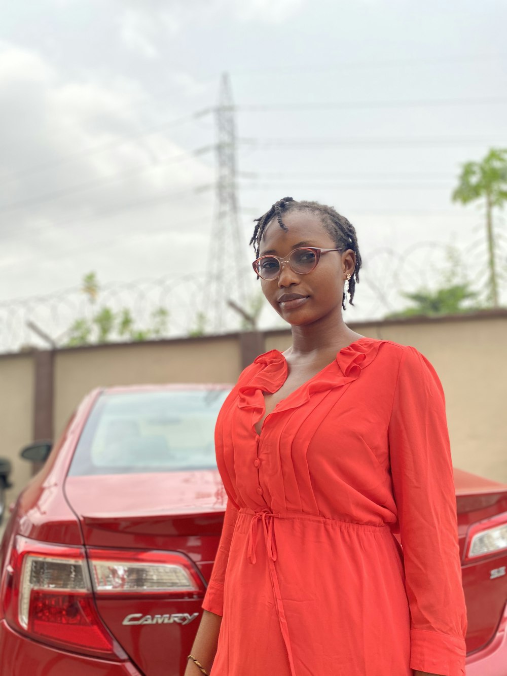 woman in red dress wearing black framed eyeglasses