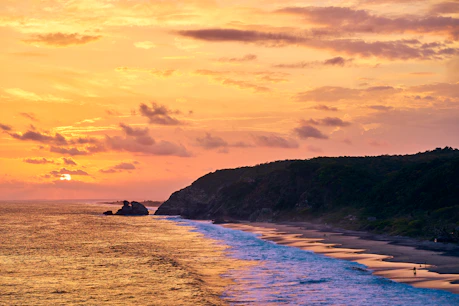 mazunte playa de oaxaca silhouette of mountain near body of water during sunset