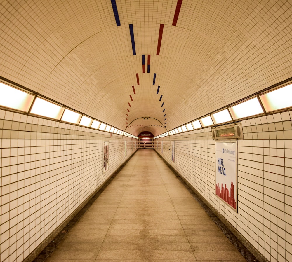 white and red cross sign on tunnel