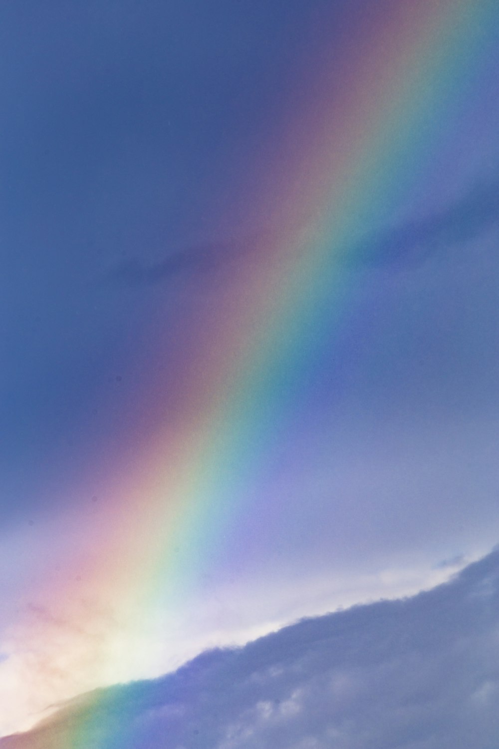 rainbow over the clouds during daytime