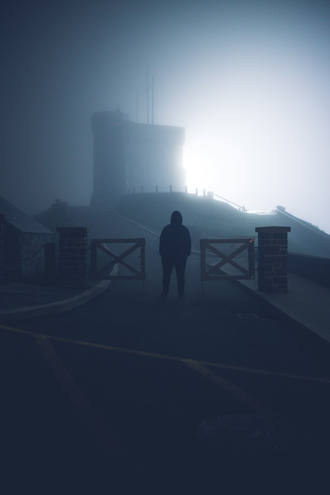 silhouette of person standing on bridge during daytime