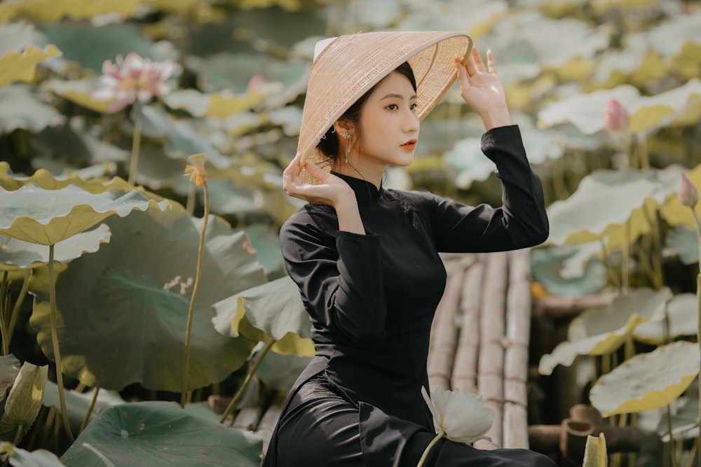 woman in black long sleeve dress wearing brown straw hat