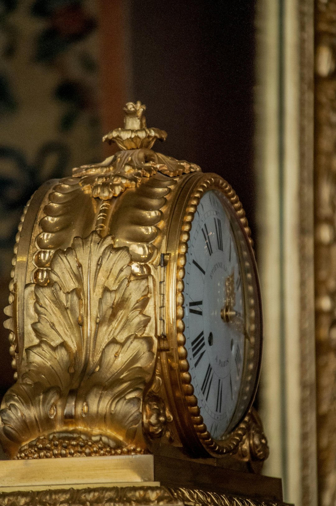 gold and white analog clock