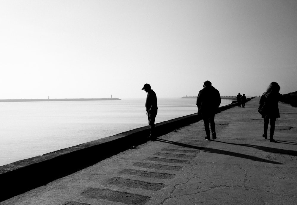 2 person walking on the beach during daytime