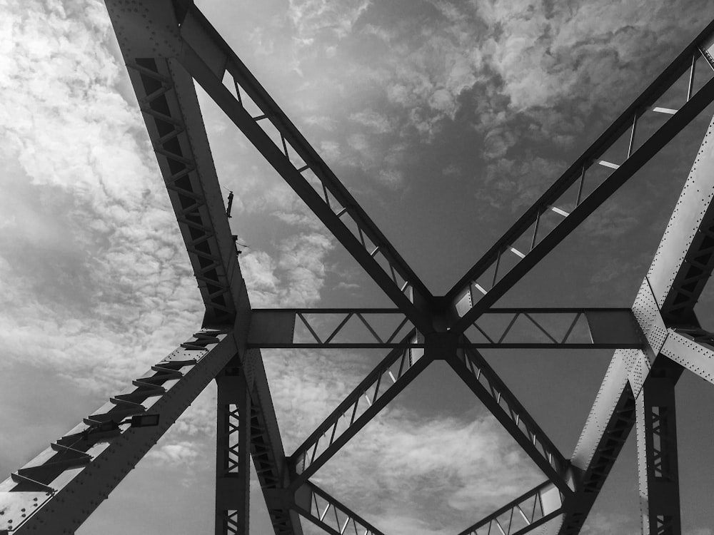 grayscale photo of metal frame under cloudy sky