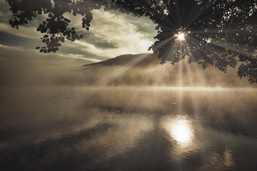 sun setting over the mountains and lake, mystic black forest nature reserve