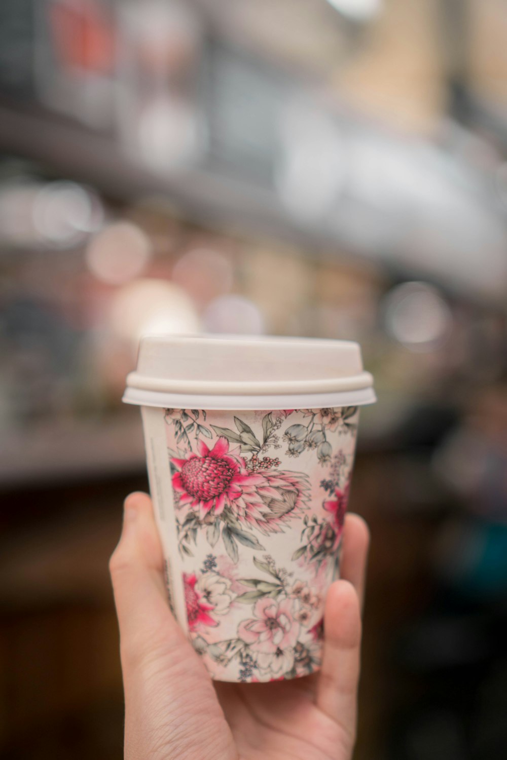 white and pink floral disposable cup