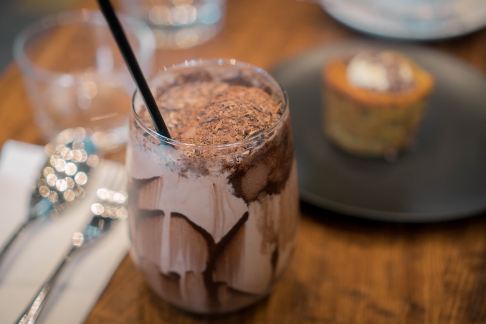 clear glass cup with brown liquid