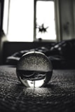 A close-up of a crystal ball on a soft surface.