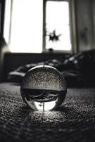 A close-up of a crystal ball on a soft surface.