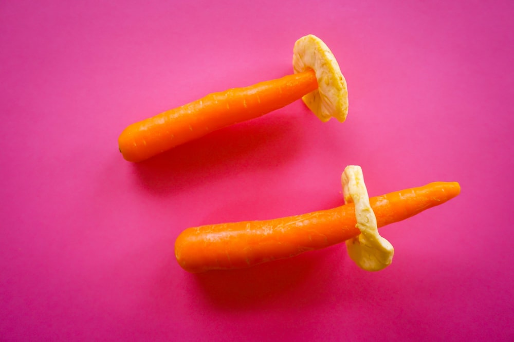 orange carrot on pink textile