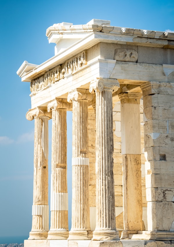 Marble columns of the Temple of Athena Nike against a blue sky