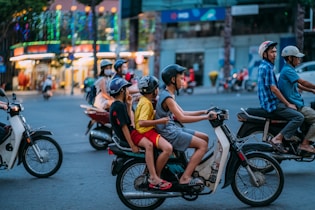 man in yellow shirt riding motorcycle with woman in yellow shirt