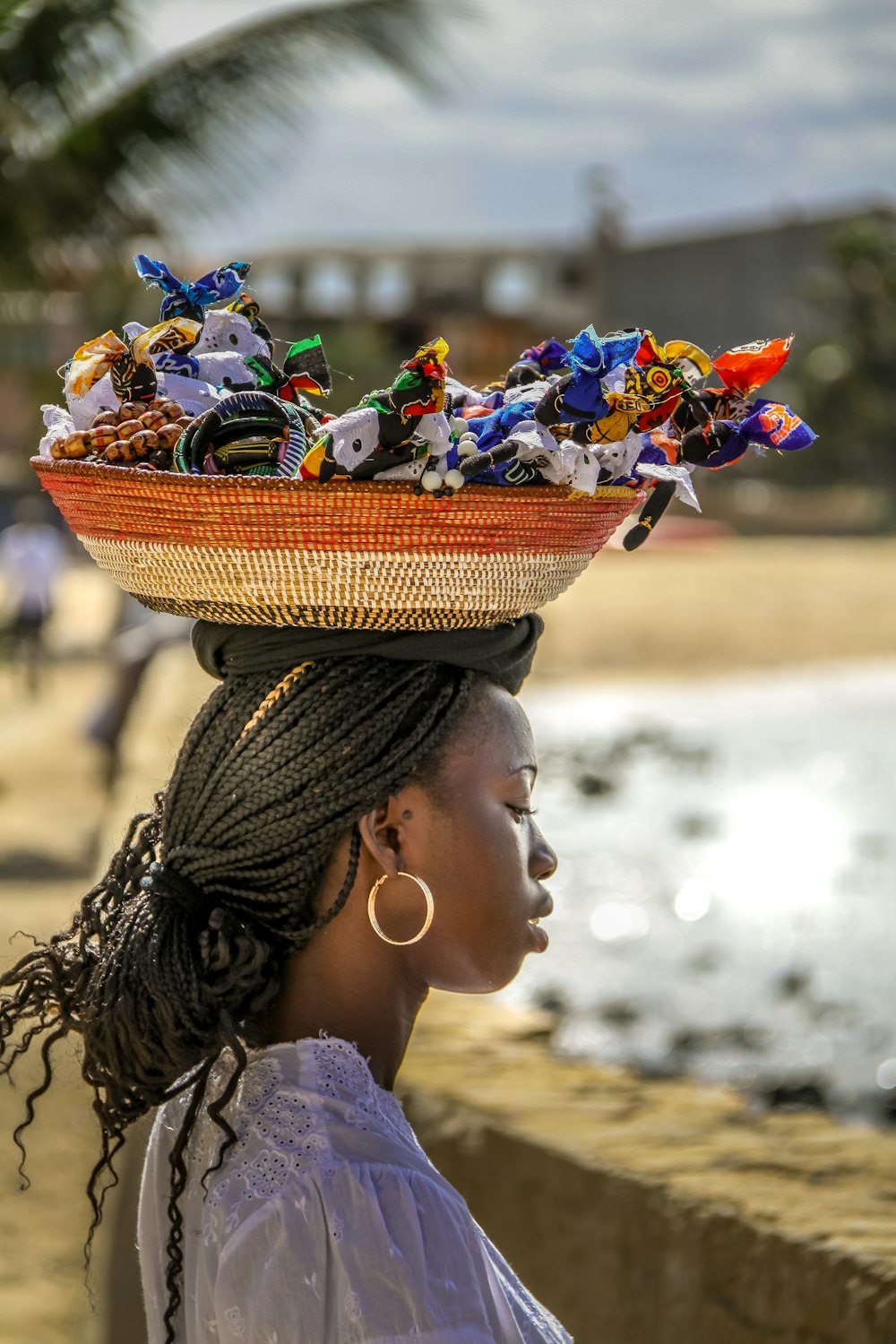 woman in brown woven hat with blue and white flower bouquet