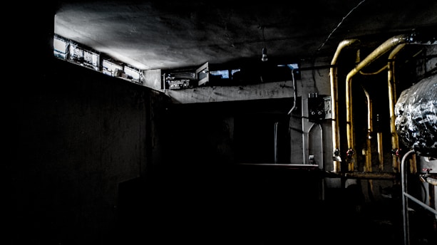 A dimly lit steampunk laboratory filled with gears, glowing tubes, and a large brass control panel, evoking a villain's lair.