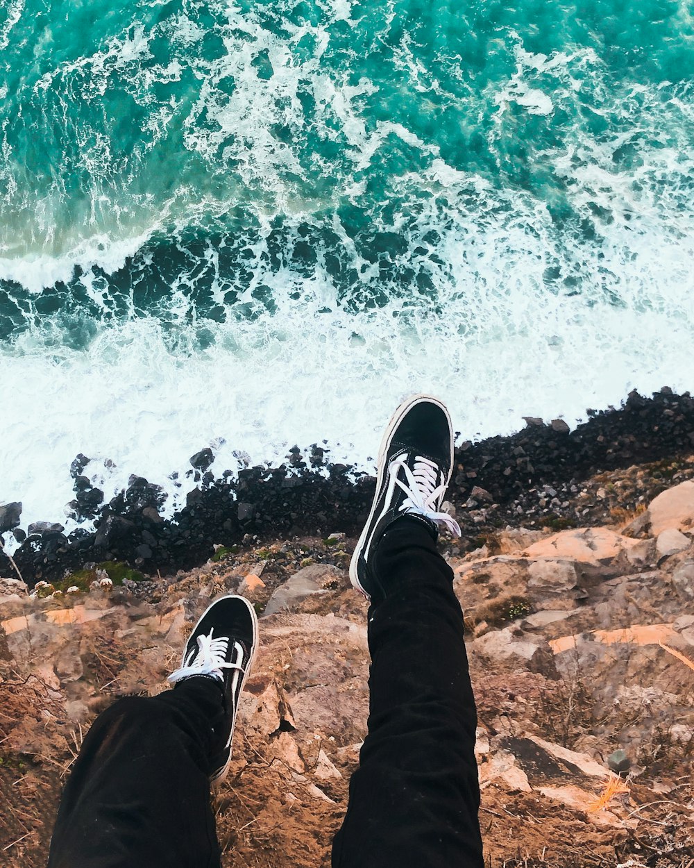 person wearing black and white sneakers