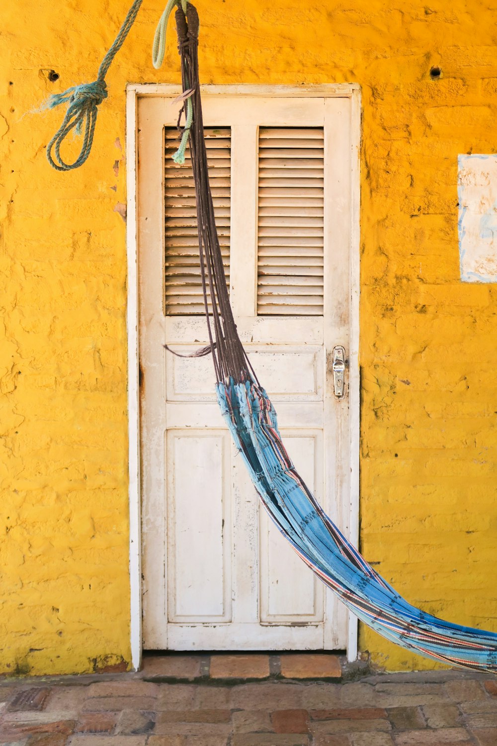 brown wooden ladder leaning on yellow painted wall