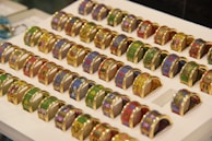 An assortment of gold rings with various traditional and contemporary designs arranged artistically.