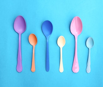 pink plastic spoon on pink and white polka dot textile