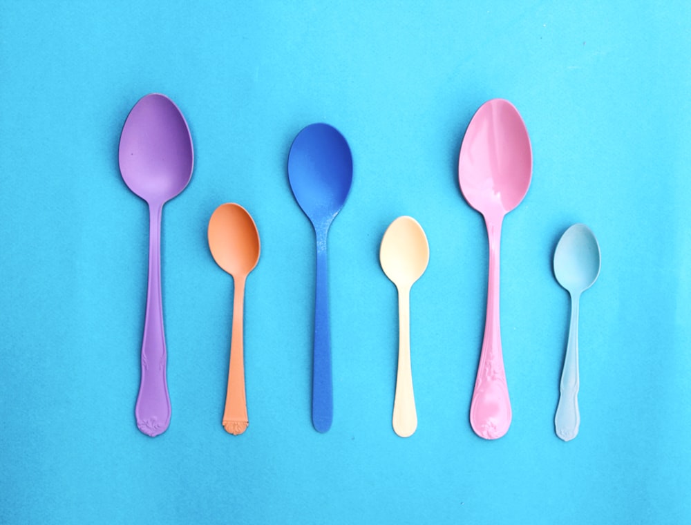 pink plastic spoon on pink and white polka dot textile