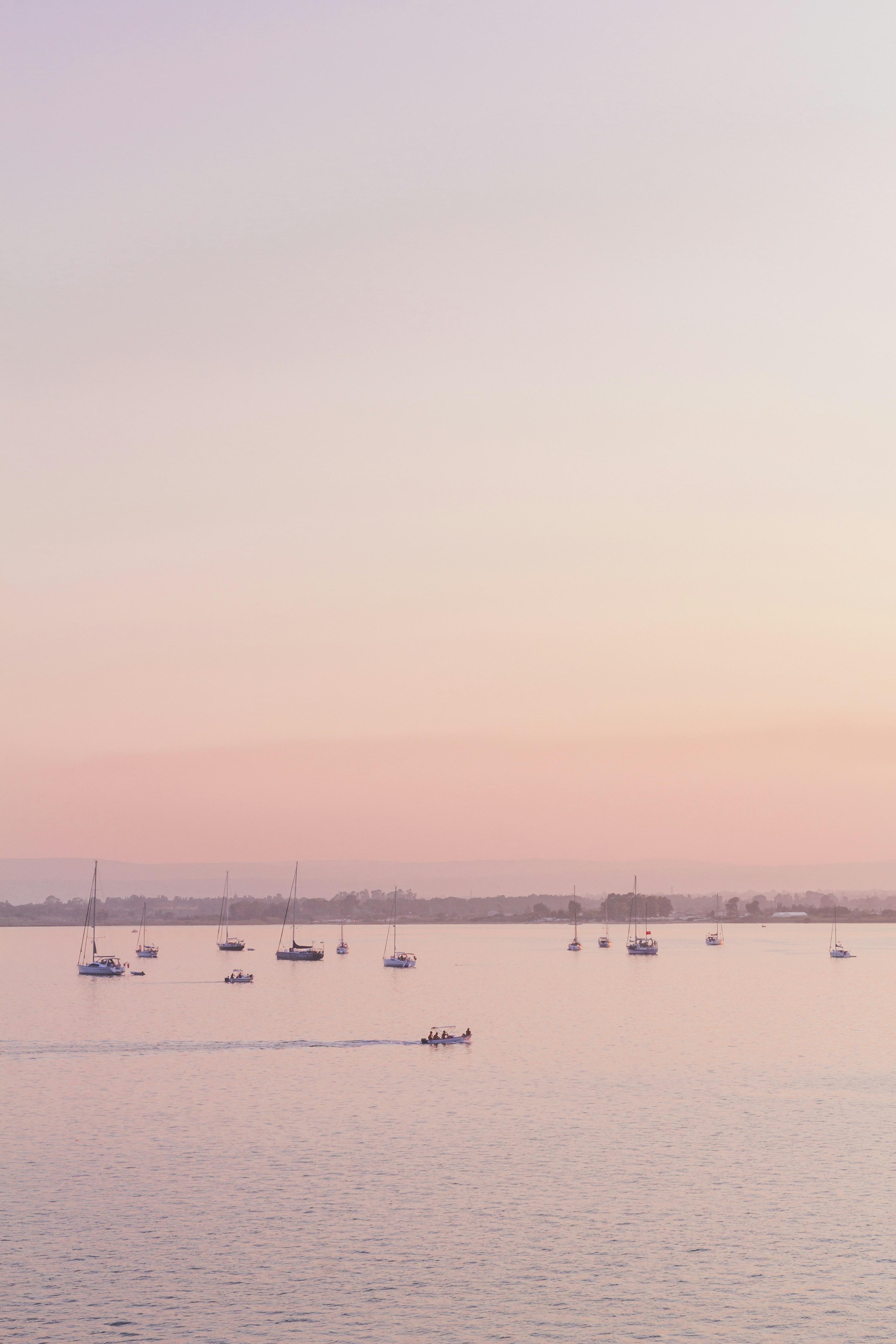 silhouette of people riding on boat on sea during daytime